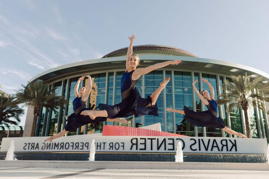 Three dance students perform outside the Kravis Center.